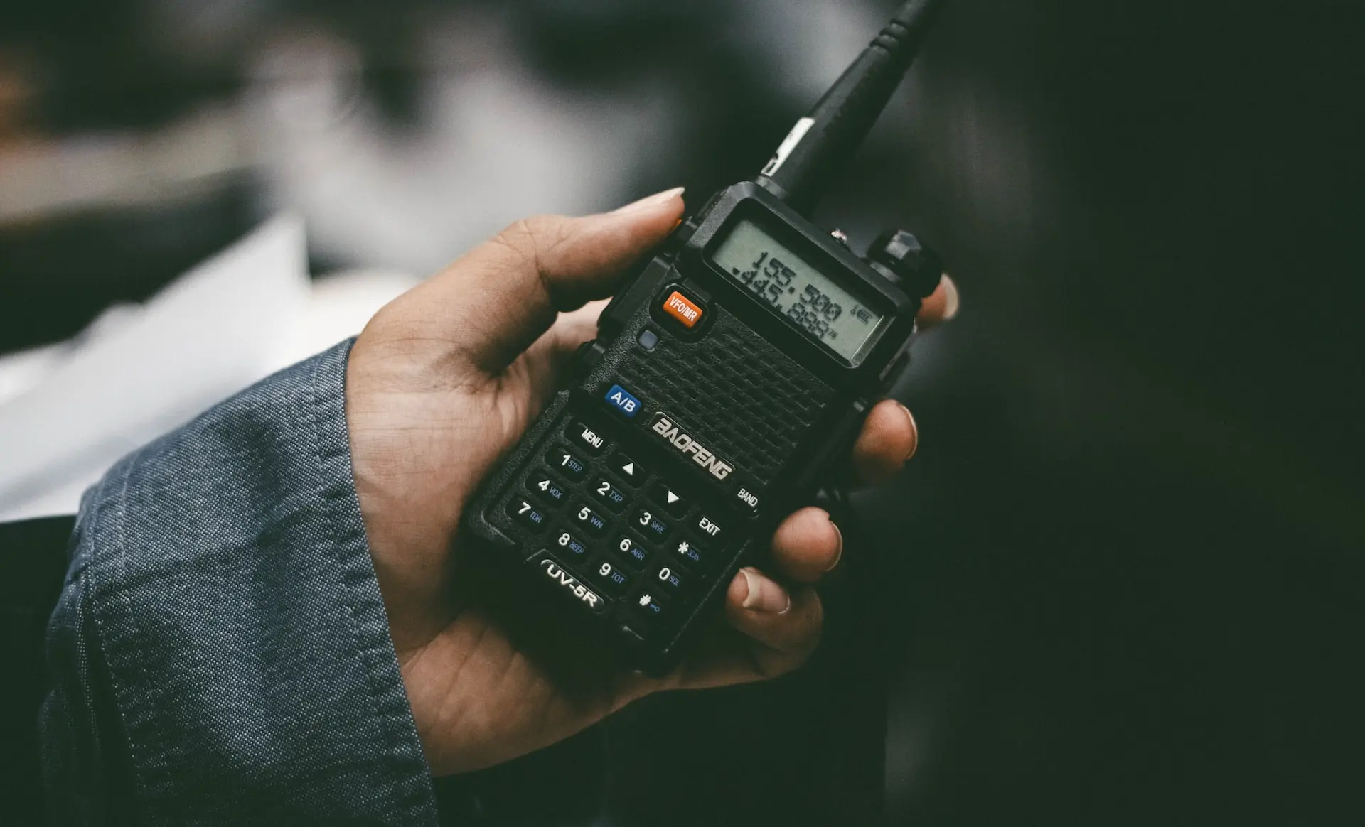 a person holding a cell phone in their hand